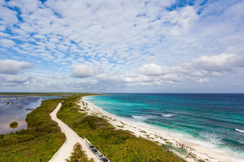 a car parked on the side of a road next to the ocean, by Carey Morris, pexels contest winner, carribean white sand, zenith view, panoramic, birds eye photograph