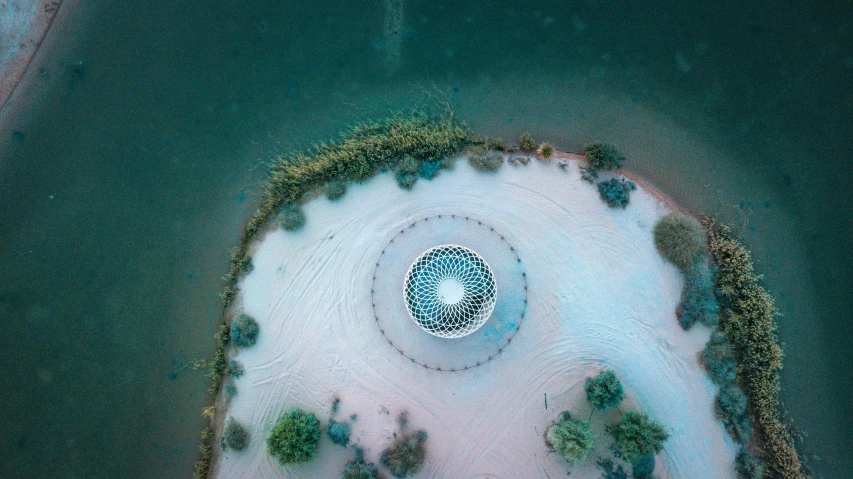 a bird's eye view of a fountain in the middle of a body of water, by Ahmed Yacoubi, pexels contest winner, land art, parametric structure, all enclosed in a circle, dreamy, in the desert beside the gulf