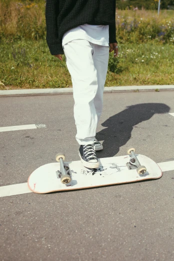 a person standing on a skateboard in a parking lot, off white, white, small, kano)