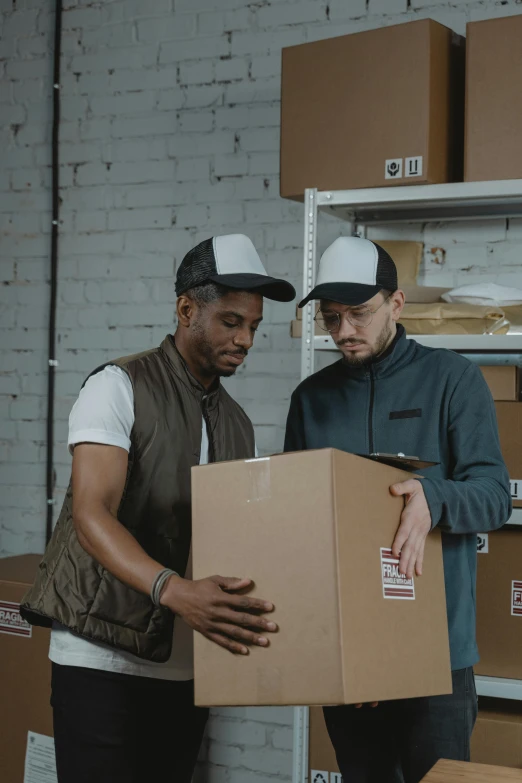 a couple of men standing next to each other holding boxes, pexels contest winner, renaissance, inspect in inventory image, thumbnail, diverse, hand holding cap brim