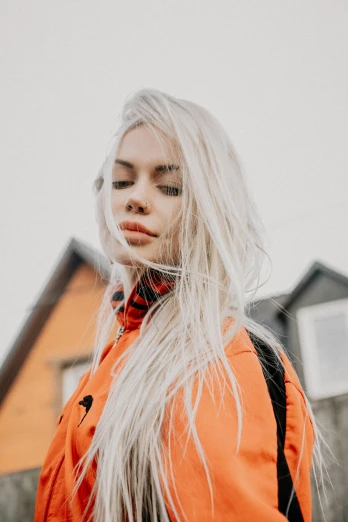 a woman with long white hair standing in front of a house, inspired by Elsa Bleda, trending on pexels, orange jacket, russian girlfriend, portait photo profile picture, trending on spotify