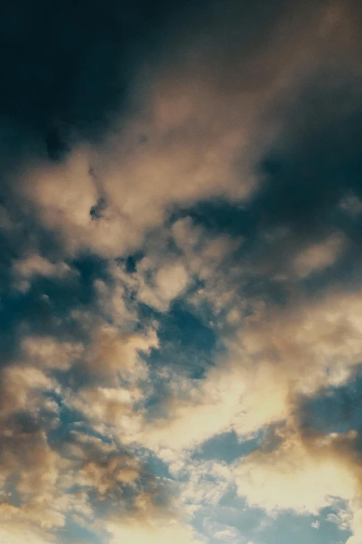 a plane flying through a cloudy blue sky, an album cover, inspired by Elsa Bleda, unsplash, romanticism, ignant, humid evening, brooding clouds', volumetric clouds