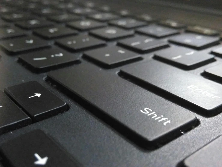 a close up of a keyboard on a laptop, by Jason Felix, pixabay, title - shift, slick!!, lit from below, panel of black