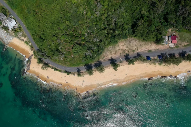 an aerial view of a sandy beach next to the ocean, by Carey Morris, pexels contest winner, hurufiyya, ( ( ( kauai ) ) ), road trip, trees around, half turned around