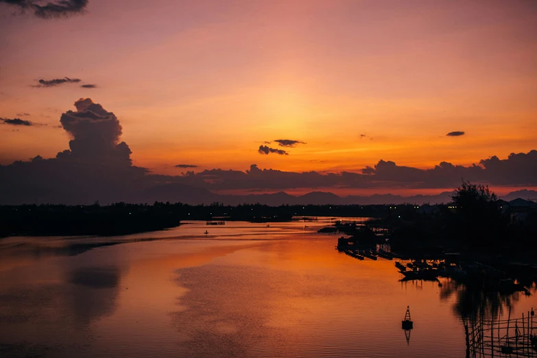 a large body of water with a sunset in the background, pexels contest winner, hurufiyya, datapipeline or river, vietnam, unsplash 4k, urban surroundings