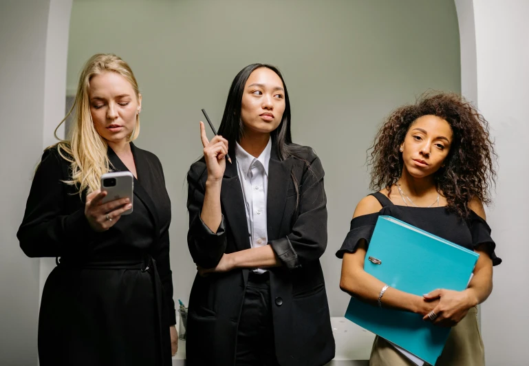 a group of three women standing next to each other, trending on pexels, realism, serious business, middle finger, lit from the side, investigation