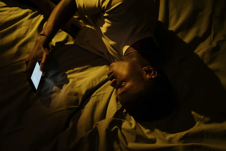 a man laying in bed using a tablet computer, by Elsa Bleda, happening, dark skin, dramatic movie still, kano), ignant