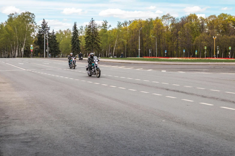 a group of people riding motorcycles down a street, a picture, by Serhii Vasylkivsky, unsplash, photorealism, spring season, panorama, 000 — википедия, street of teal stone