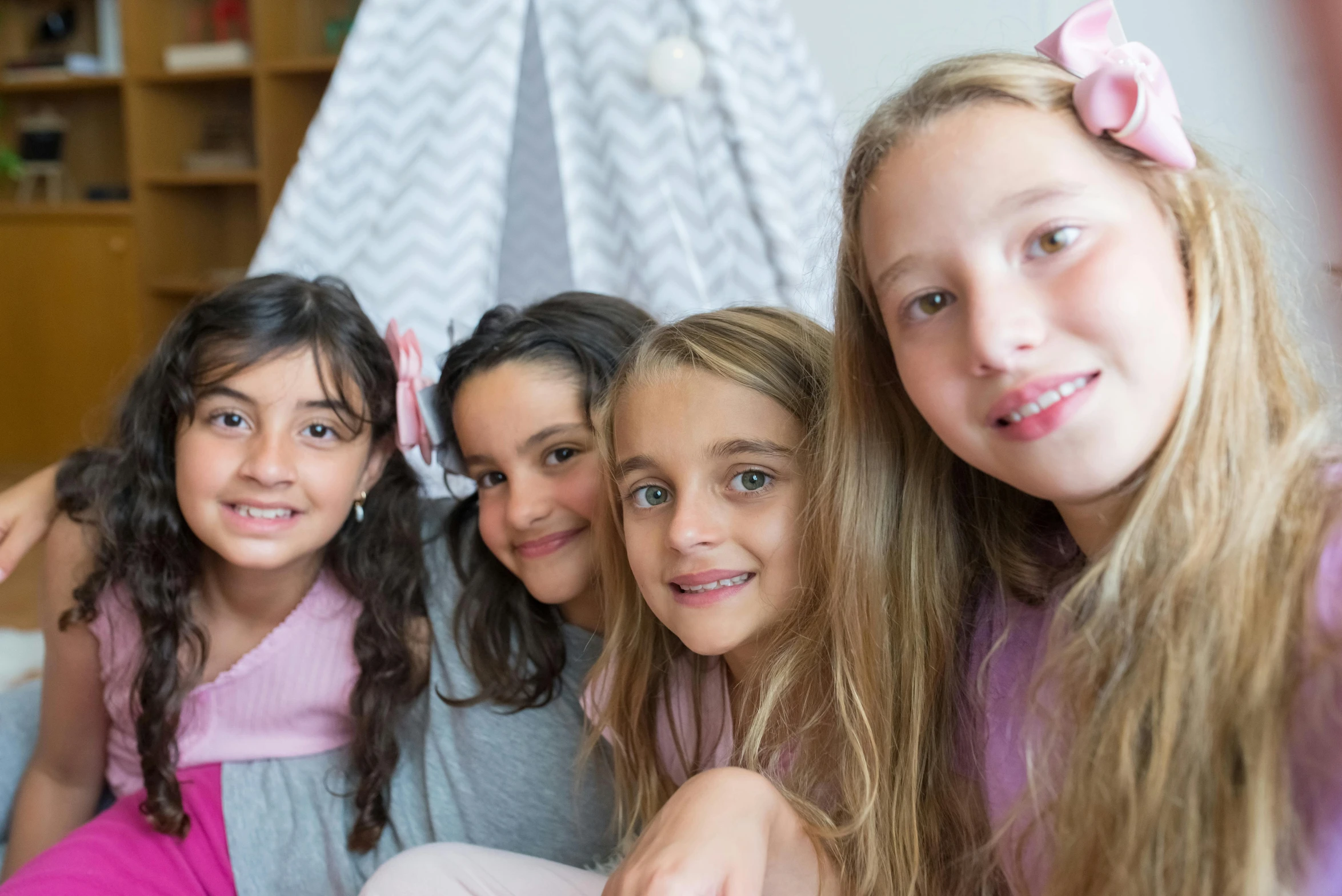 a group of young girls sitting on top of a bed, pexels contest winner, incoherents, close up head shot, 15081959 21121991 01012000 4k, petite girl, middle eastern skin