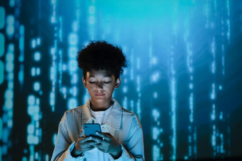 a close up of a person holding a cell phone, a hologram, afrofuturism, teenage girl, programming, binary, getty images