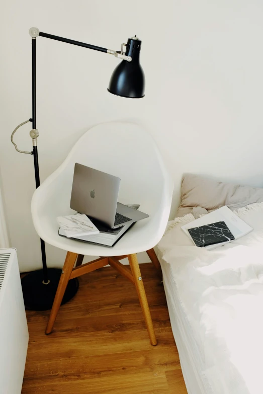 a laptop computer sitting on top of a white chair, by Niko Henrichon, small and cosy student bedroom, clean and organized, large)}], image