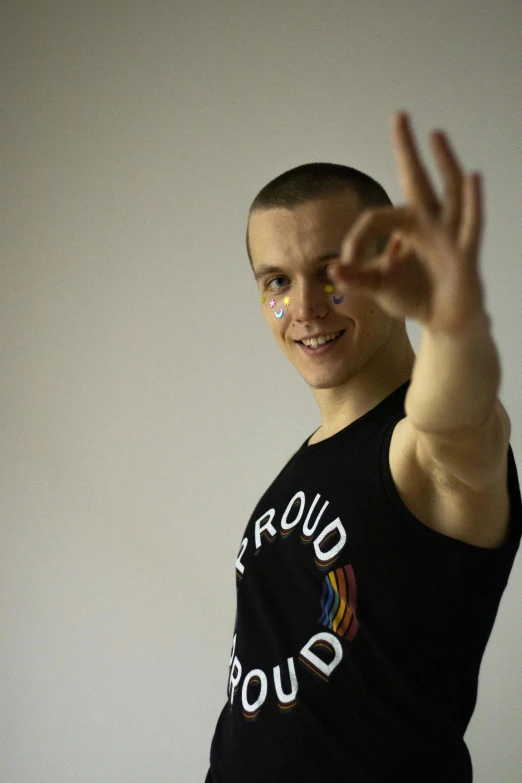 a man in a black shirt is making a peace sign, inspired by Alexander Litovchenko, adam ondra, no rainbow, profile image, buzz cut