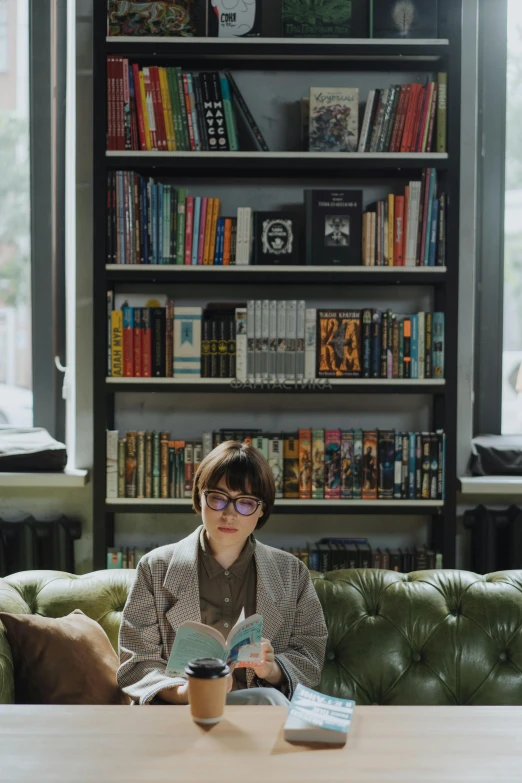 a woman sitting on a couch reading a book, art & language, rebecca sugar, russian academic, sitting in a cafe, non-binary