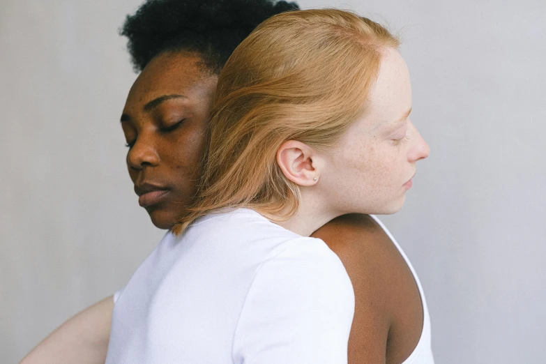 a couple of women standing next to each other, by Carey Morris, trending on pexels, renaissance, skin color, hugging, white neck visible, ( redhead