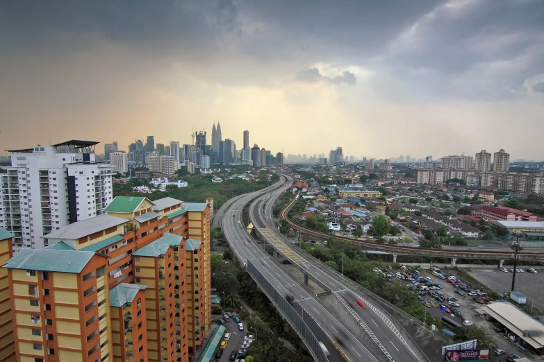 a view of a city from a high rise building, a matte painting, by Basuki Abdullah, pexels contest winner, hurufiyya, highways, malaysian, slight overcast, panorama