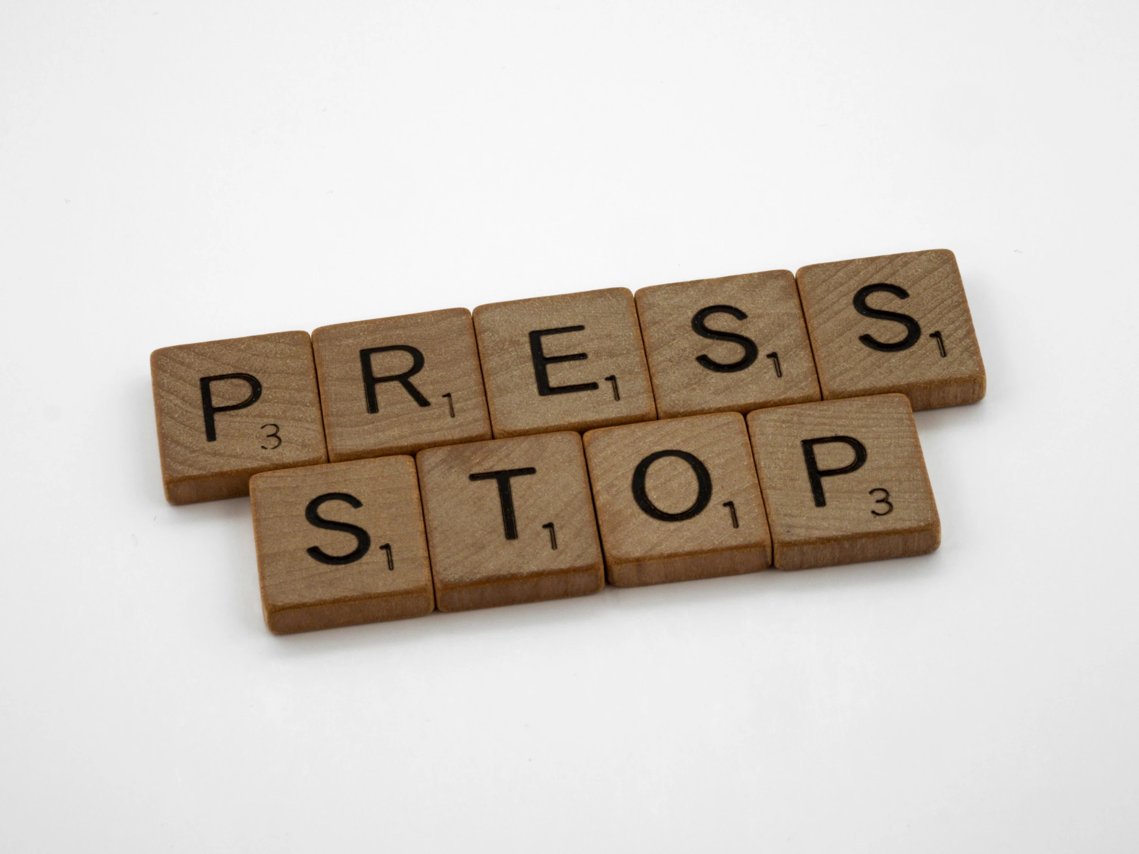 a wooden block with the word press stop written on it, a cartoon, unsplash, private press, newspaper comic strip, on grey background, oscar winning, compressed jpeg