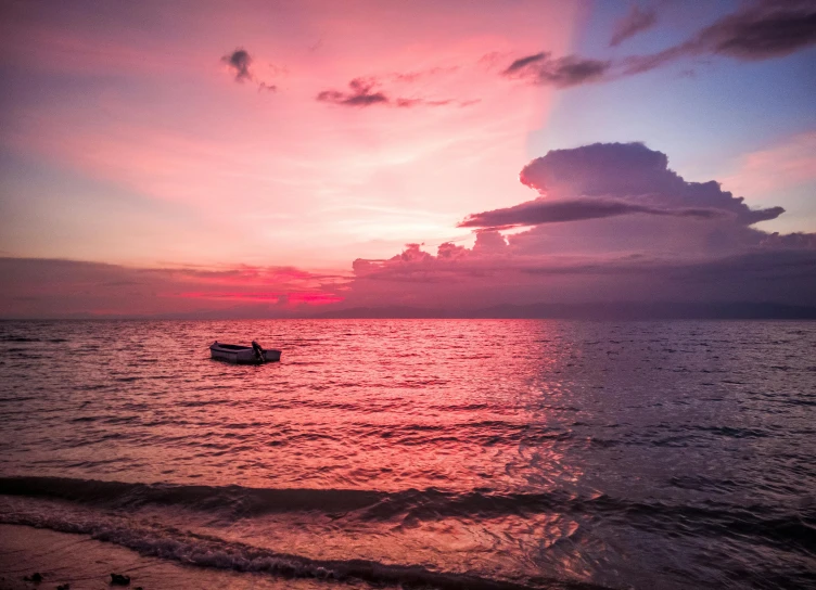 a boat floating on top of a body of water, by Robbie Trevino, pexels contest winner, romanticism, pink clouds, jamaica, at beach at sunset, slide show