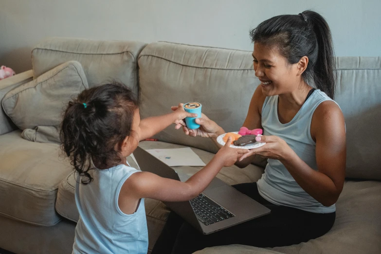 a woman and a little girl sitting on a couch, pexels contest winner, serving happy meals, avatar image, cardistry, asian female