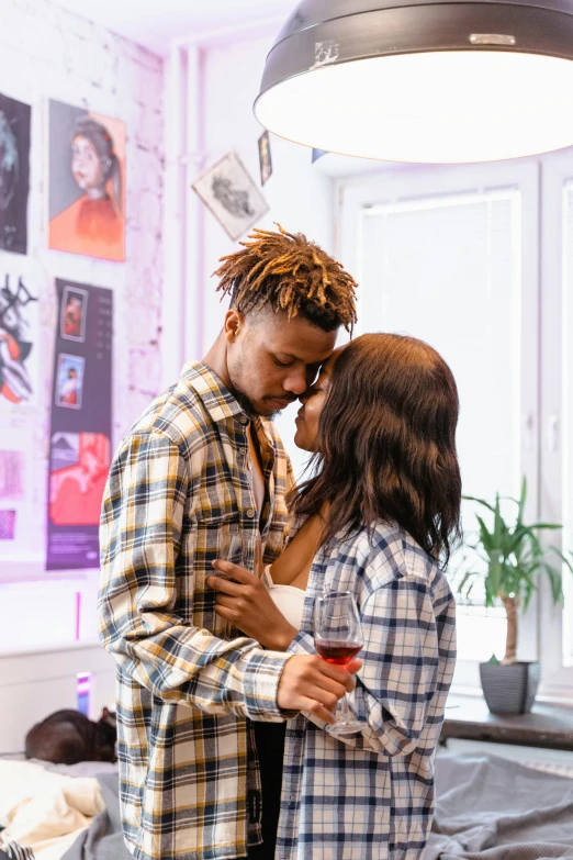 a man and woman standing next to each other in a bedroom, an album cover, trending on pexels, visual art, black young woman, drinking, embracing, impression