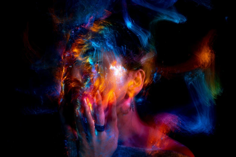 a woman with her hands on her face, by Adam Marczyński, pexels, psychedelic art, tendrils of colorful light, facepalm, abstract painting of man on fire, trapped egos in physical reality