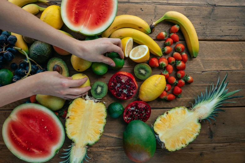 a table topped with lots of different types of fruit, pexels contest winner, hand on table, avatar image, background image, full frame image