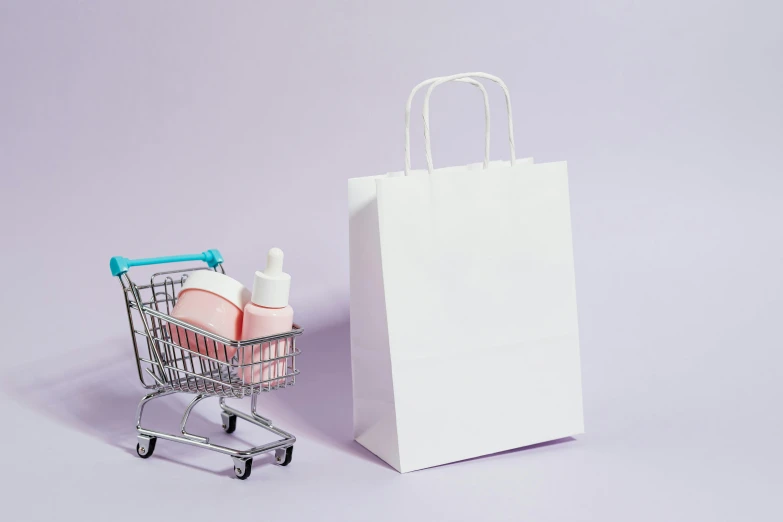 a shopping cart sitting next to a shopping bag, by Eden Box, aestheticism, background image, skincare, whitespace, toddler