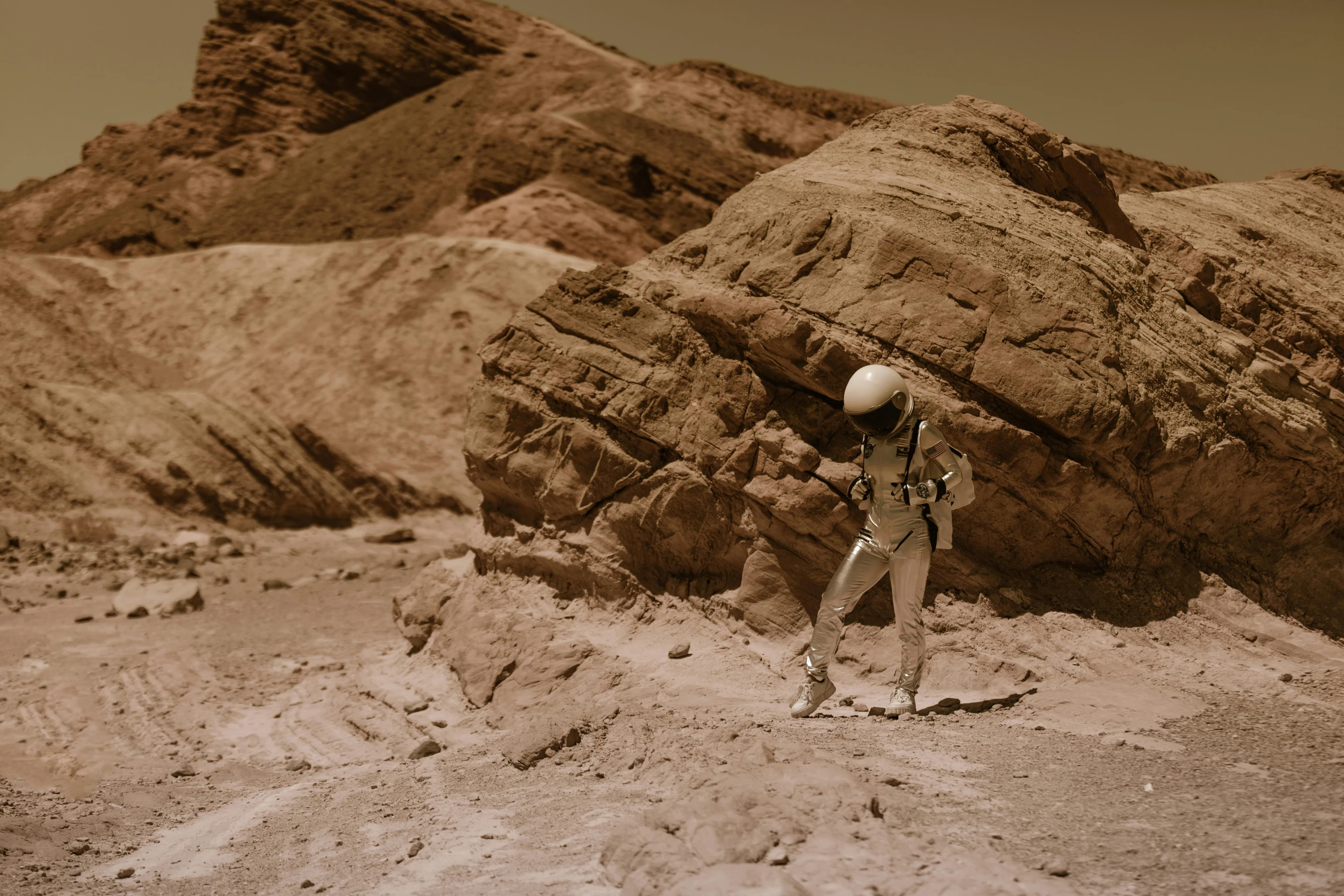 a man that is standing in the dirt, a detailed matte painting, inspired by Filip Hodas, unsplash contest winner, beautiful woman in spacesuit, sepia photography, geology, mars vacation photo