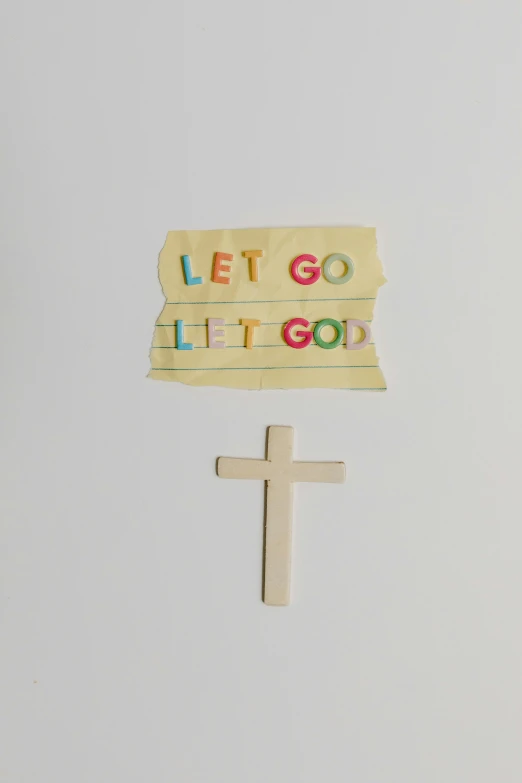 a cross and a piece of paper that says let go to god, an album cover, unsplash, conceptual art, - 9, story, kek, aftermath