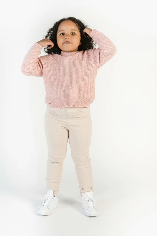a little girl standing with her hands on her head, pastel pink skin tone, wearing pants, promo image, full body hero