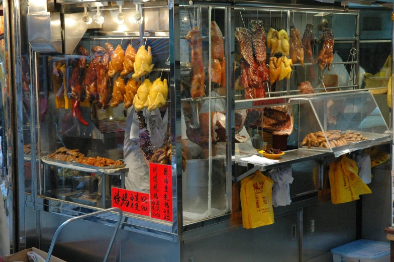 a man standing in front of a food stand, looking like a bird, city like hong kong, meat machine, warmly lit