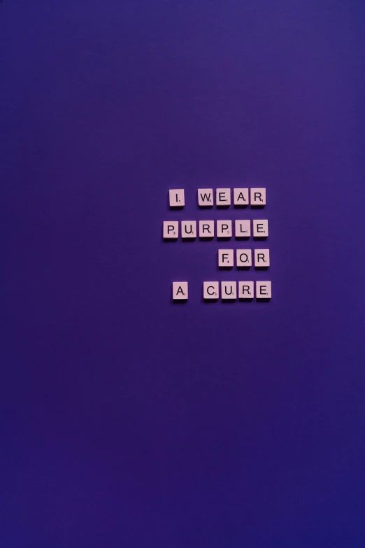 a purple laptop computer sitting on top of a desk, an album cover, inspired by Yves Klein, unsplash, words, puzzle, purple outfit, the cure