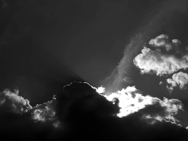 a black and white photo of a cloudy sky, unsplash, shining light and shadow, dramatic lighting))), sun after a storm, cloud in the shape of a dragon