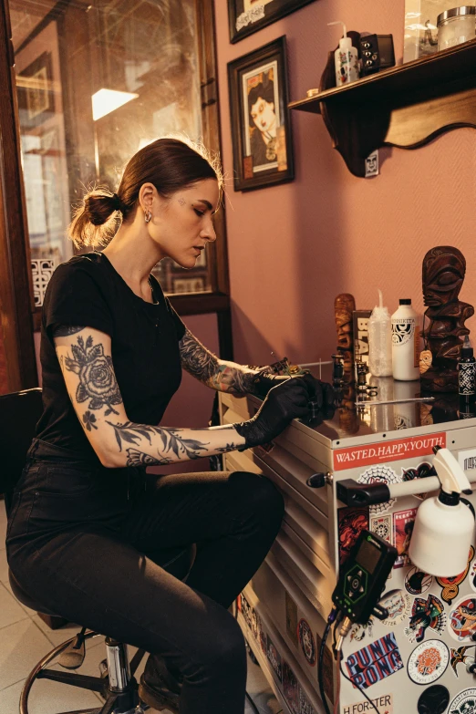 a woman sitting on a stool in a tattoo parlor, elbow gloves, felix englund style, hands on counter, profile image