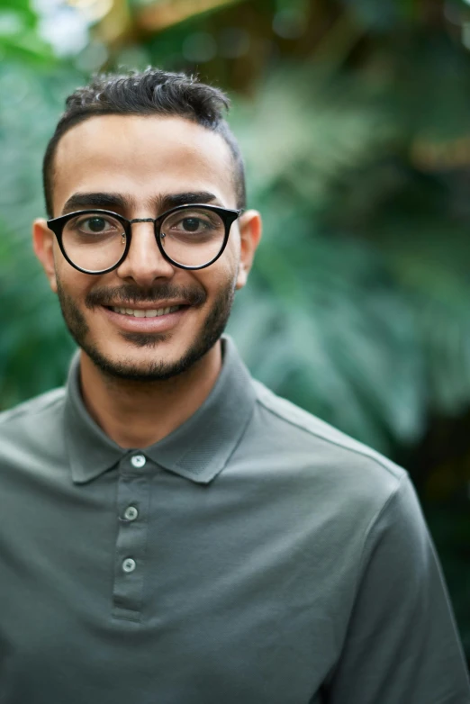 a man with glasses smiling at the camera, inspired by Ahmed Yacoubi, lgbtq, 2019 trending photo, aged 2 5, multiple stories