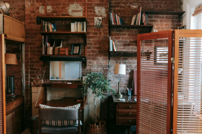 a living room filled with furniture and a brick wall, a portrait, unsplash, wooden desks with books, document photo, background image, meredith schomburg