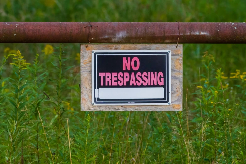 a no trespassing sign hanging on a gate, by Julia Pishtar, pexels, no trees or grass, thumbnail, studio photo, sewer pipe entrance