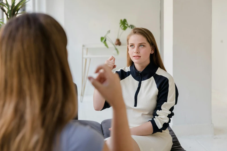 a woman sitting in front of a mirror brushing her teeth, trending on pexels, sitting on the couch, acupuncture treatment, emma watson sitting in chair, hypnosis