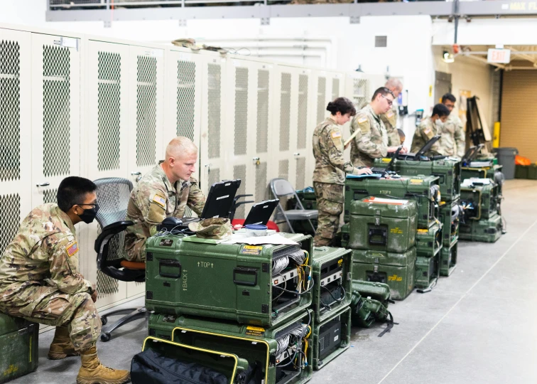 a group of men in military uniforms working on laptops, military storage crate, radio equipment, taken in 2 0 2 0, instagram post