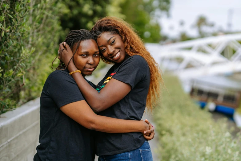 a couple of women standing next to each other, a portrait, unsplash, happening, black teenage girl, lesbian embrace, 15081959 21121991 01012000 4k, environmental shot