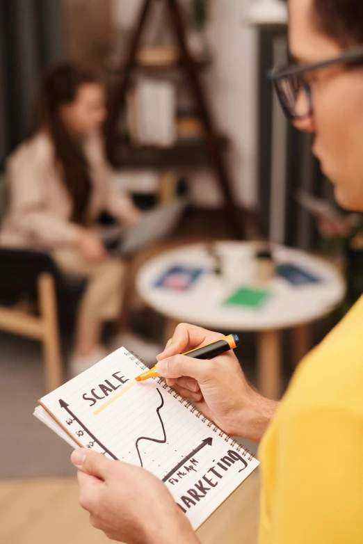 a woman in a yellow shirt writing on a notepad, a picture, trending on pexels, analytical art, scale, holding a staff, teacher, graphs