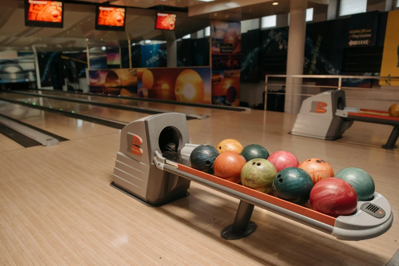 a row of bowling balls in a bowling alley, by Tom Bonson, dribble, grey orange, jovana rikalo, thumbnail, mid shot photo