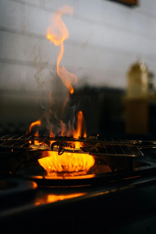 a close up of a frying pan on a stove, by Matt Cavotta, pexels, fire and smoke columns, made of glazed, dessert, outdoor photo