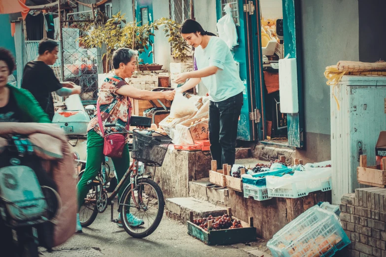 a group of people riding bikes down a street, by Daniel Lieske, pexels contest winner, getting groceries, chinese woman, avatar image, vintage color photo