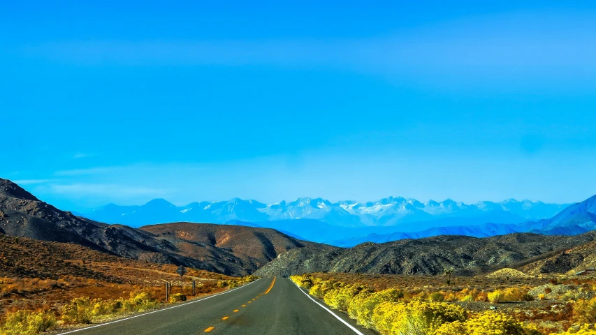 an empty road with mountains in the background, by Whitney Sherman, square, 4k -, blue sky, chartreuse and orange and cyan