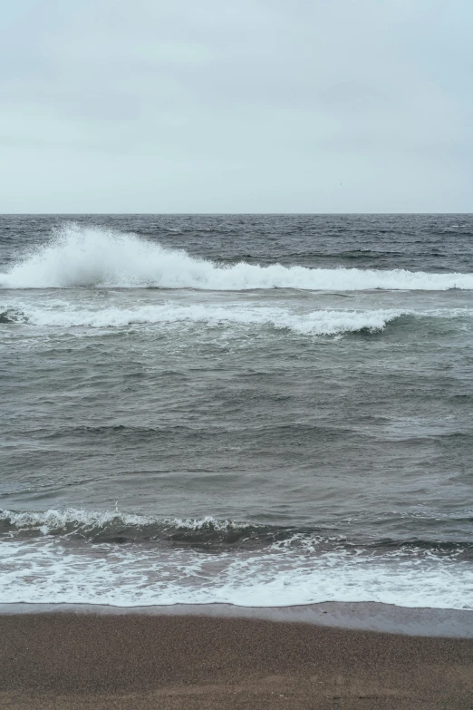 a man riding a wave on top of a surfboard, by Hirosada II, happening, overcast!!!, red sand beach, very very low quality, bubbling geysers