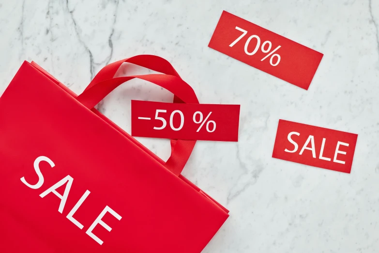 a red shopping bag sitting on top of a table, placards, images on the sales website, on a pale background, 7 0 % ocean