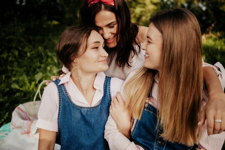 a group of young women sitting next to each other, a picture, by Emma Andijewska, trending on pexels, arm around her neck, happy family, wearing blue jean overalls, avatar image