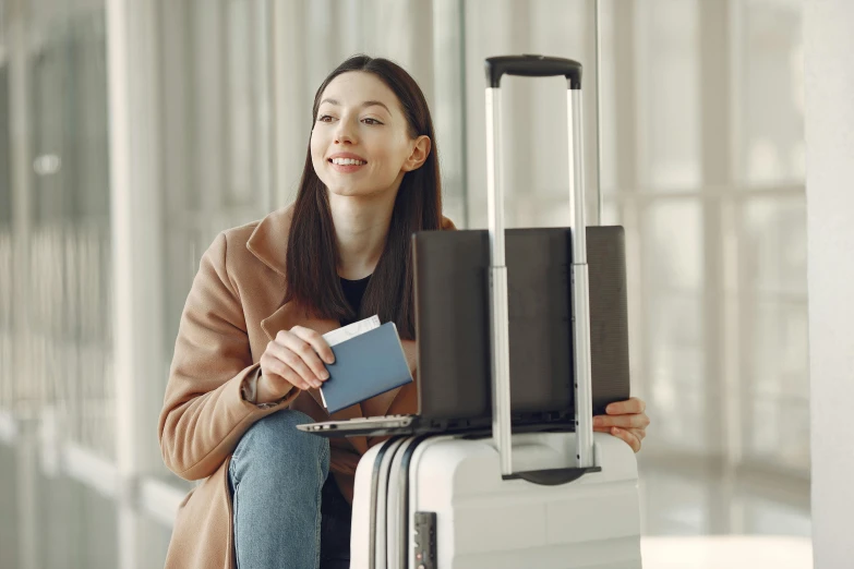 a woman sitting on top of a suitcase holding a passport, profile image, aussie, grey, smooth technology