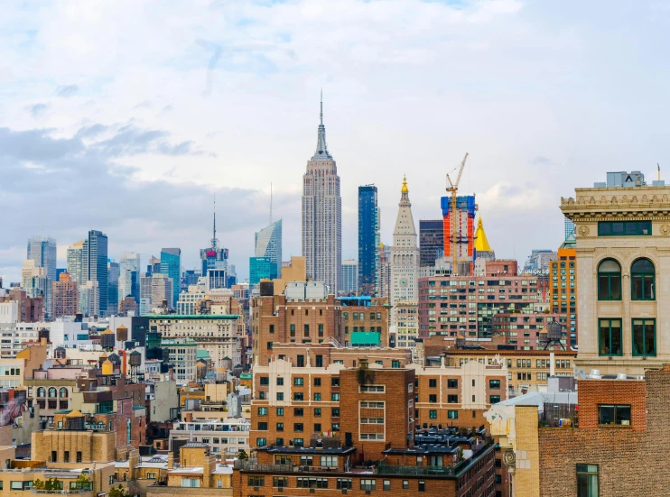 a view of a city from the top of a building, new york city as backdrop, abcdefghijklmnopqrstuvwxyz, multicoloured, cities