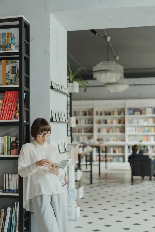 a woman reading a book in a library, pexels contest winner, modernism, wearing a white button up shirt, exiting store, gif, asian women